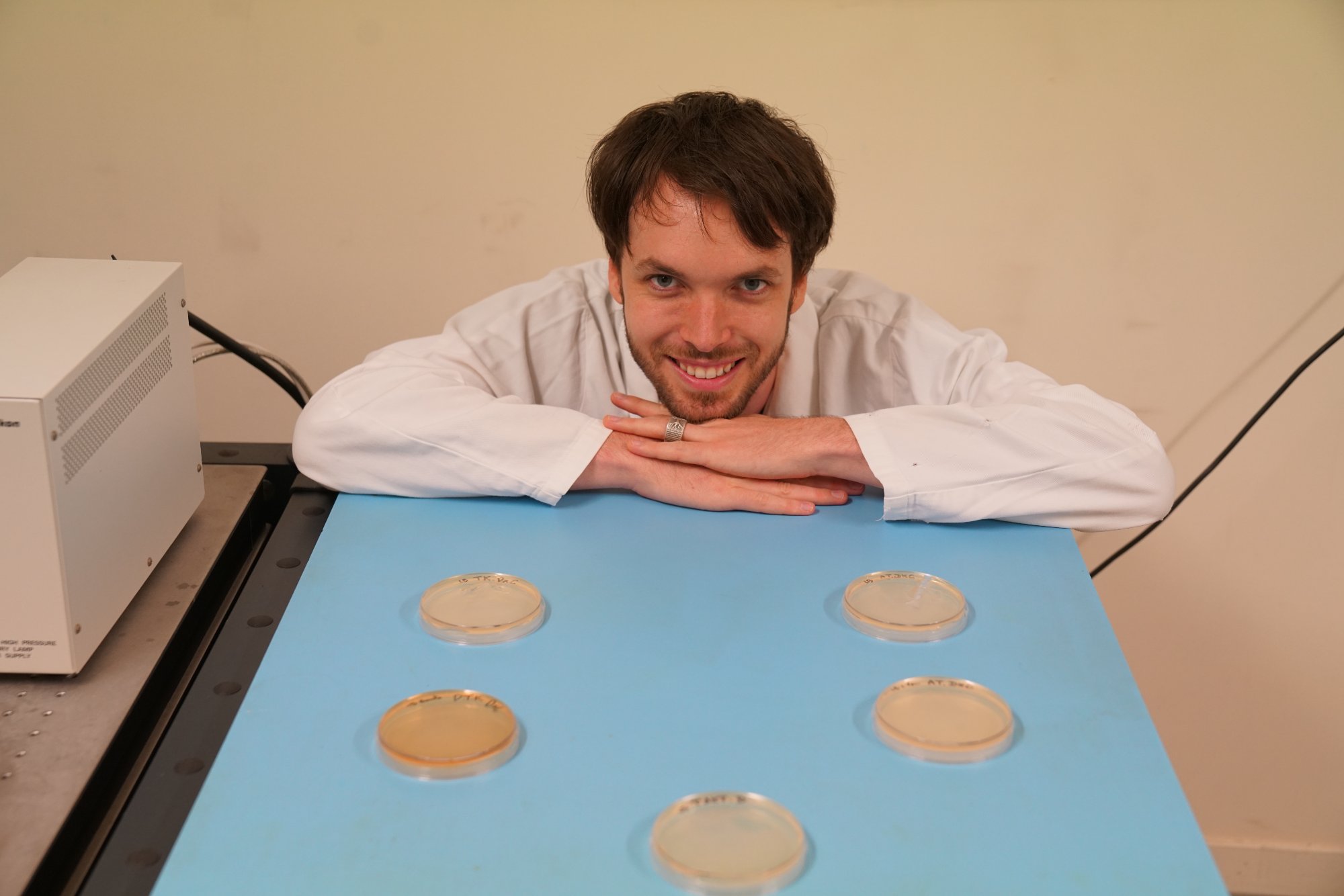 Tyler with petri dishes in lab