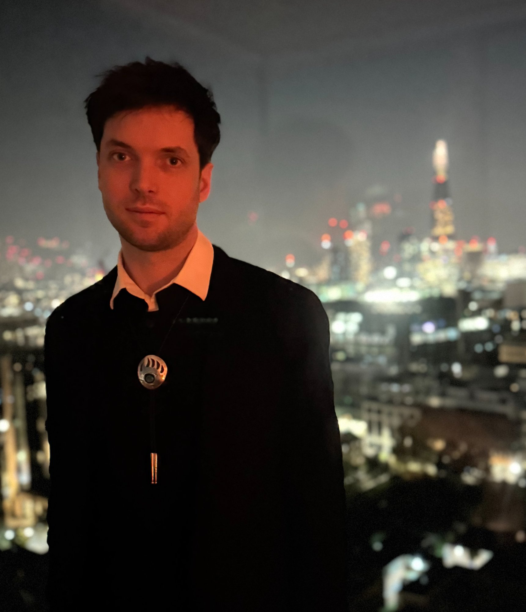 Tyler with city skyline at night